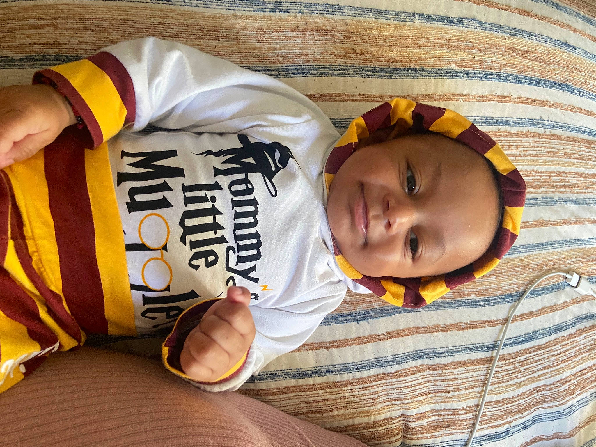 Shia is registered to the contest to win money with this photo: baby, baby_toddler_clothing, bedding, bedtime, blanket, child, comfort, elbow, flooring, happy, linens, mammal, nap, pattern, person, room, sitting, sleeve, thumb, toddler