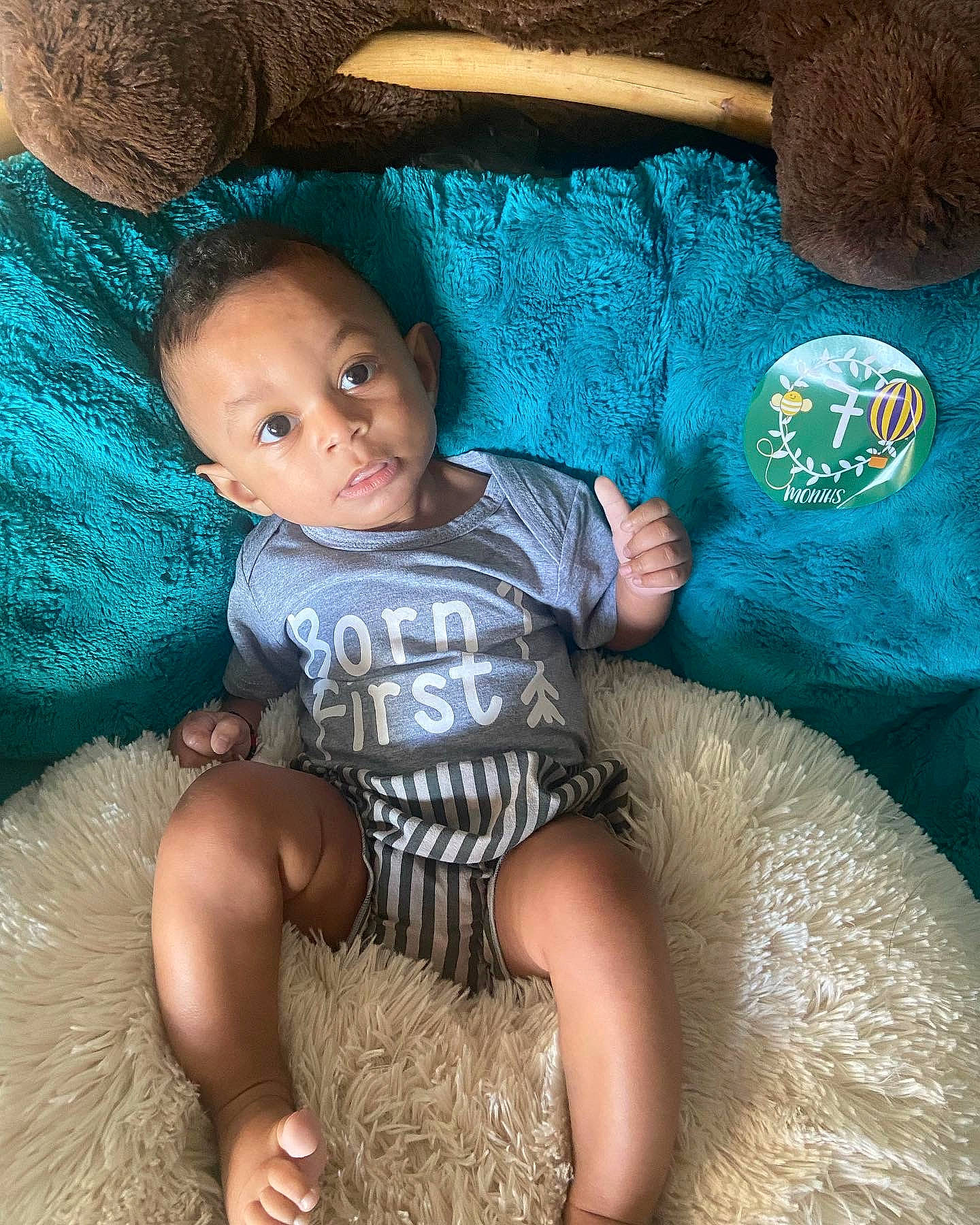 Shia is registered to the contest to win money with this photo: abdomen, baby, baby_toddler_clothing, child, comfort, cool, couch, electric_blue, fun, happy, human_leg, lap, linens, mammal, person, sitting, skin, t_shirt, thigh, toddler