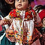 Daivik joined the competition — help win amazing prizes! baby, woman, traditional_clothing, colorful, indoor, portrait, person, child, holding, face, head, fabric, pattern, adult, human, celebration, event, candid, blur, curious