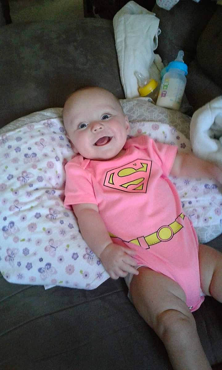 Megan joined the competition — help win amazing prizes! baby_products, cheek, child, day, eye, face, finger, hair, head, human_hair_color, infant, leg, mouth, person, pink, product, sitting, skin, smile, textile