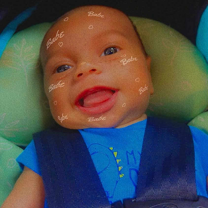 Elija joined the competition — help win amazing prizes! baby, car_seat, child, smiling, blue_clothing, face_filter, digital_overlay, happy, infant, seatbelt, portrait, closeup, cute, tongue_out, straps, head_support, child_seat, baby_boy, child_safety, car_interior