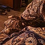 Rowdy joined the competition — help win amazing prizes! cat, tabby, sleeping, blanket, patterned_blanket, indoor, cozy, feline, resting, paws, fur, relaxed, warm_lighting, wood_floor, home, comfort, quiet, animal, pet, domestic_cat