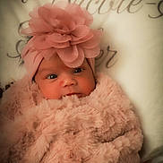Harper joined the competition — help win amazing prizes! baby, infant, newborn, headband, flower_headband, pink, plush_blanket, fur_blanket, cozy, portrait, closeup, face, eyes, hat, bedding, soft_texture, cute, swaddled, blanket, accessory