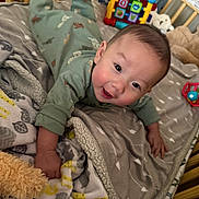 Zion joined the competition — help win amazing prizes! baby, crib, blanket, pajamas, toy, smiling, infant, face, child, bedroom, soft, colorful, cute, playtime, happy, indoors, lying_down, comfort, warm, young_child