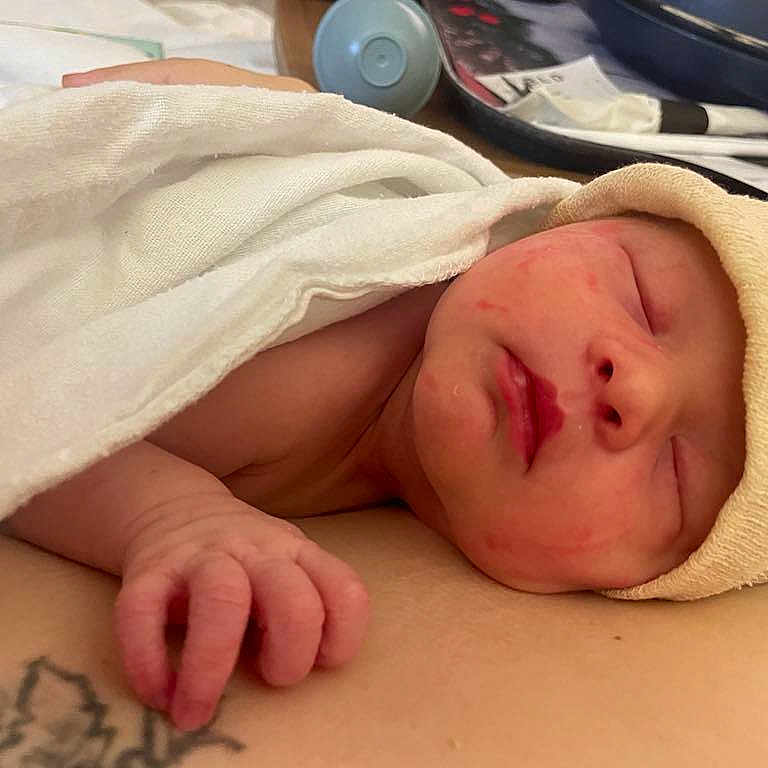 Delilah is registered to the contest to win money with this photo: architecture, baby, blanket, building, childbirth, clothing, face, glove, happy, hat, head, hospital, newborn, person, photography, portrait, sleeping, smile