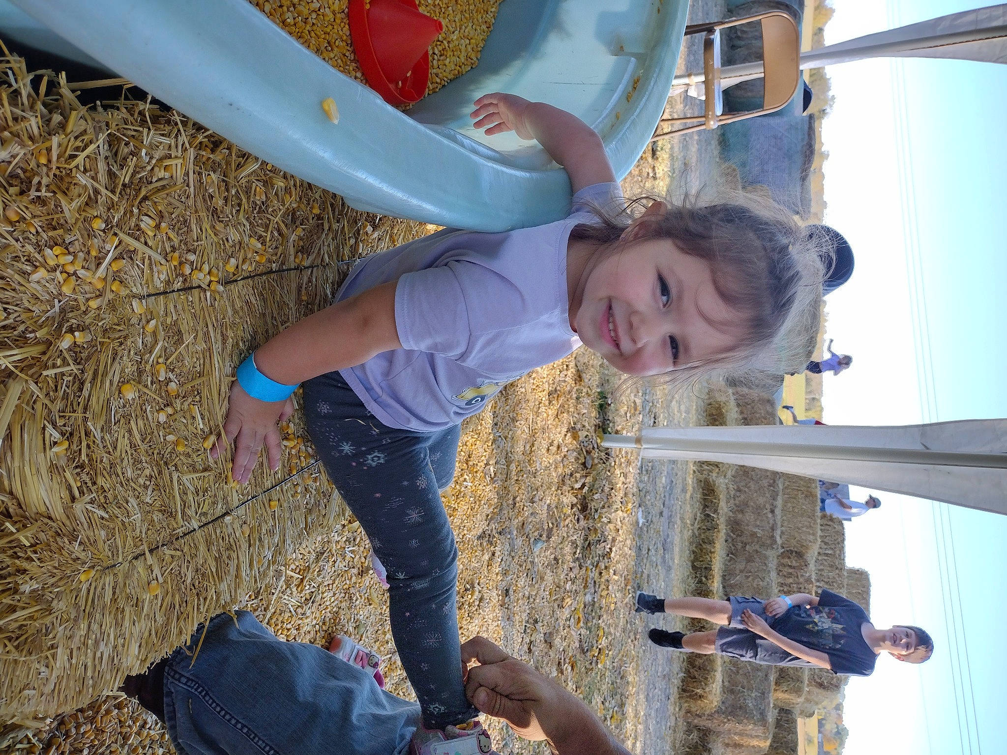Peyton is registered to the contest to win money with this photo: blue, child, city, elbow, electric_blue, fun, happy, joy, leisure, outdoor_play_equipment, people_in_nature, person, photograph, play, playground, recreation, sky, smile, soil, toddler