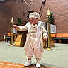 Emiliano joined the competition — help win amazing prizes! toddler, child, traditional_clothing, church, indoor, smiling, boy, hat, white_shoes, brick, altar, religious, decor, carpet, formal, cute, portrait, baby, young_child, standing