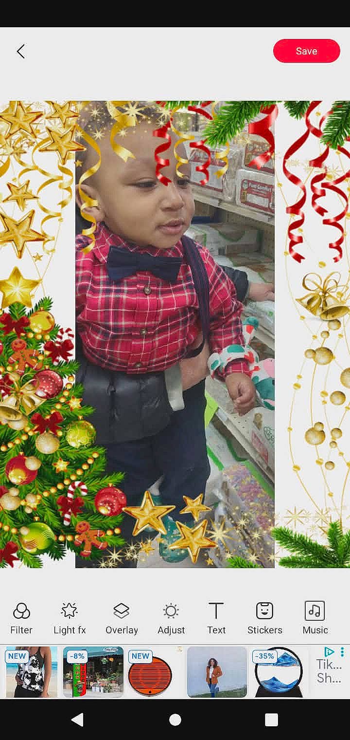 Dominic joined the competition — help win amazing prizes! bow_tie, child, christmas_decorations, christmas_tree, face, hand, holiday, indoor, mobile_app_ui, plaid_shirt, portrait, ribbons, screenshot, smile, stars, sticker_frame, store_shelves, suspenders, toddler, toys