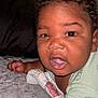 Alexander is registered to the contest to win money with this photo: arm, baby, blanket, child, close_up, clothing, comfort, couch, curly_hair, expression, face, head, indoors, infant, lying_down, mouth_open, pillow, skin, soft_surface, young_child