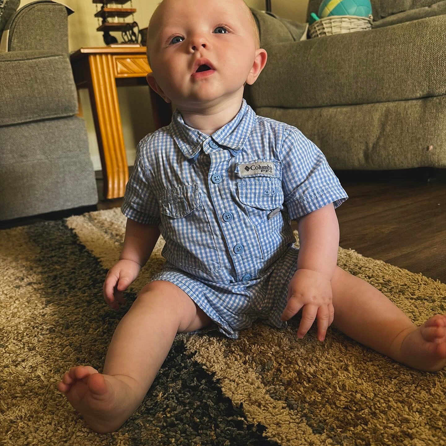 Huxley is registered to the contest to win money with this photo: architecture, baby, building, clothing, couch, cushion, face, furniture, head, homedecor, indoors, livingroom, pants, person, photography, portrait, room, sitting, sleeve, standing