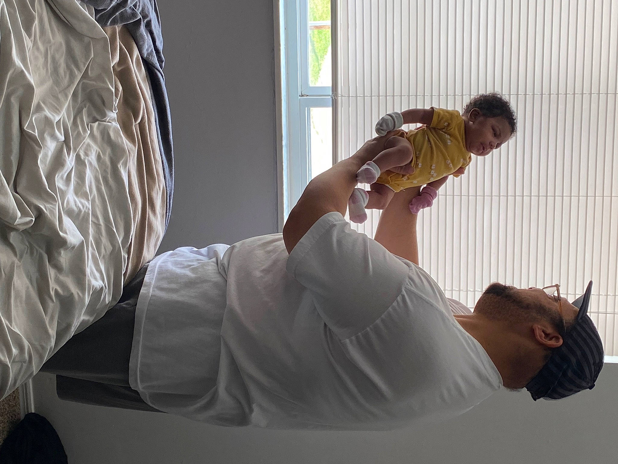 Kenya is registered to the contest to win money with this photo: comfort, elbow, finger, fun, gesture, hand, human_leg, joint, knee, linens, person, plaster, room, shoulder, sitting, window, wood, wrist