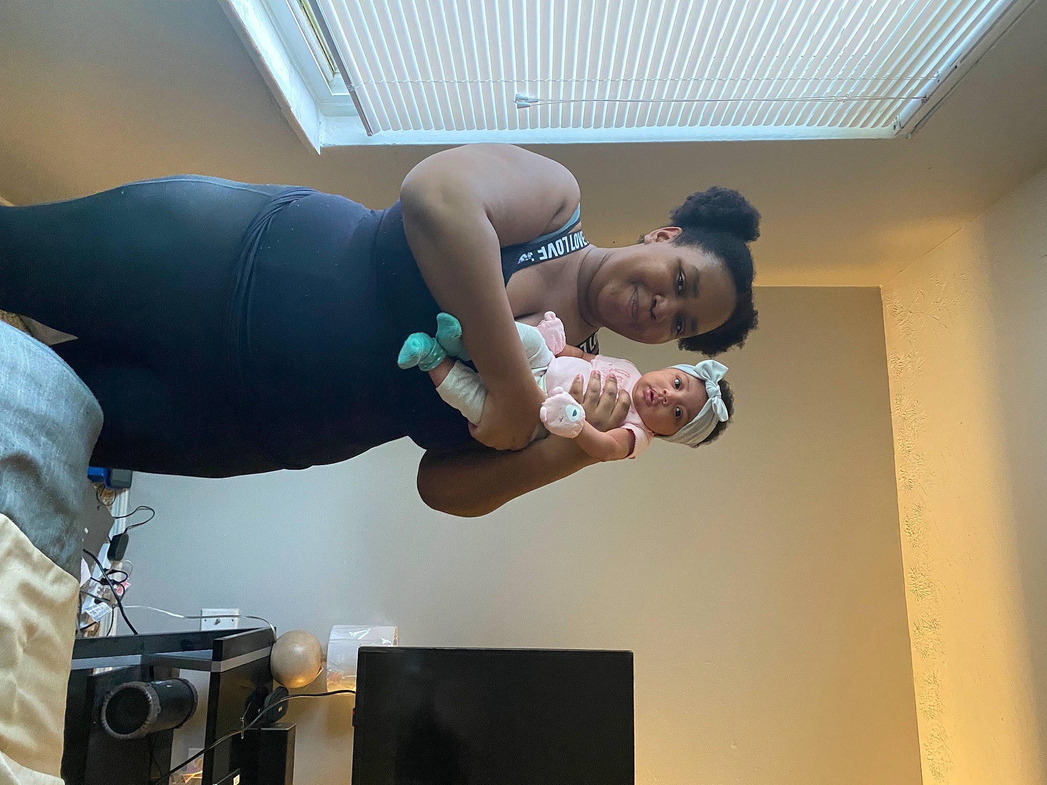 Kenya is registered to the contest to win money with this photo: abdomen, audio_equipment, baby, ceiling, chest, child, comfort, elbow, flash_photography, fun, gesture, happy, headwear, human_leg, joy, knee, loudspeaker, person, room, thigh