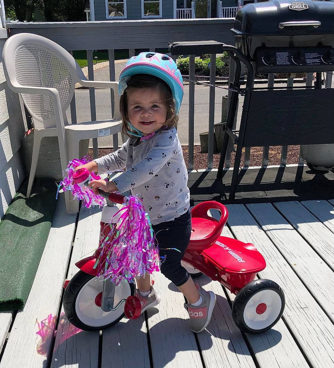 Callie joined the competition — help win amazing prizes! baby_carriage, baby_toddler_clothing, chair, child, fun, joy, leisure, magenta, outdoor_furniture, person, product, recreation, riding_toy, rolling, sitting, smile, tire, toddler, toy, travel