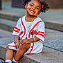 Alanna joined the competition — help win amazing prizes! toddler, child, smiling, pigtails, red_bows, jewelry, bracelet, necklace, sports_jersey, minnie_mouse, sneakers, socks, sitting, stone_steps, outdoor, happy, portrait, cute, person, fashion