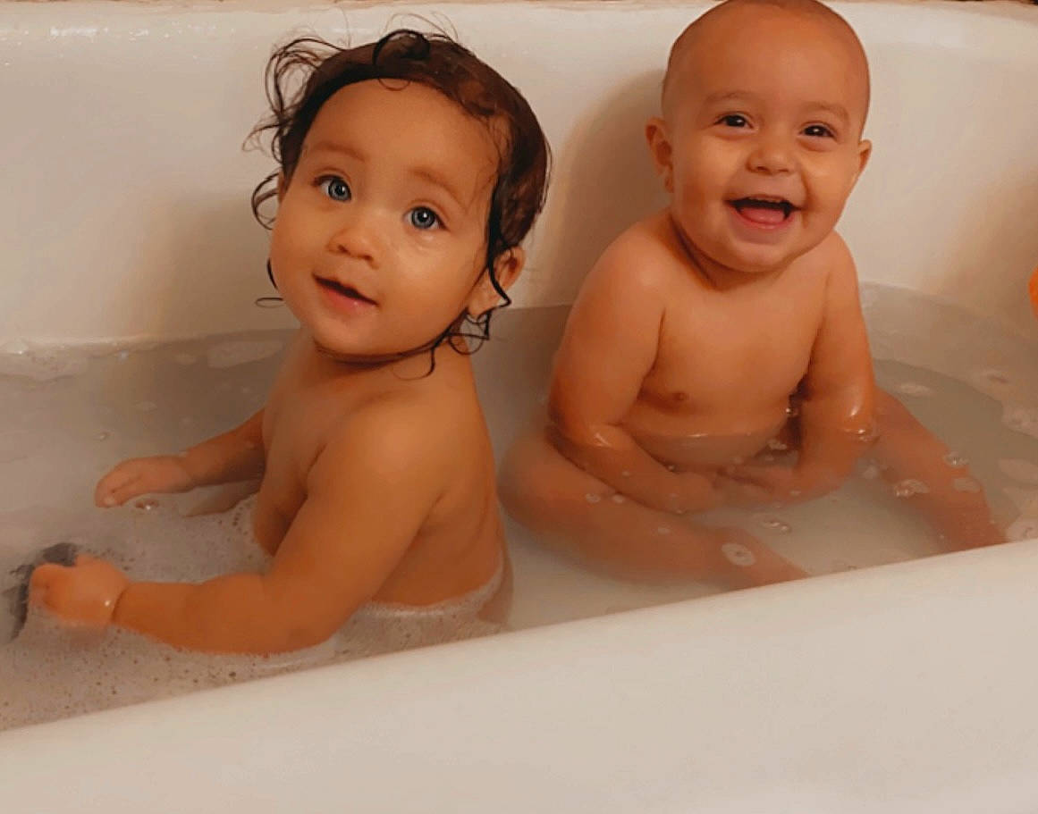 Khloe is registered to the contest to win money with this photo: baby_bathing, bathing, bathroom, bathtub, cheek, chin, eyebrow, face, fluid, hairstyle, hand, human_body, iris, joy, nose, person, photograph, skin, smile, toddler