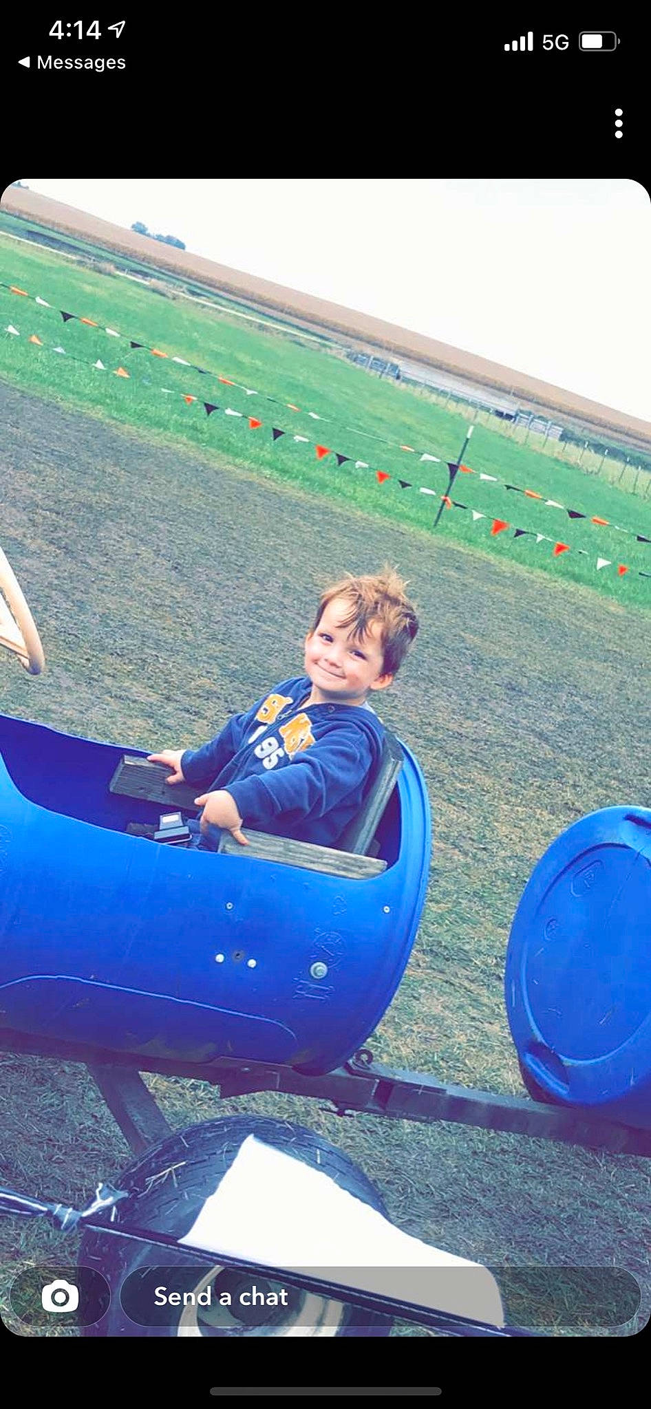 Declan is registered to the contest to win money with this photo: air_travel, automotive_exterior, ball, boats_and_boating_equipment_and_supplies, bumper, electric_blue, fun, grass, grassland, inflatable, joy, landscape, leisure, outdoor_play_equipment, outdoor_recreation, people_in_nature, person, play, recreation, sitting