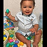 Zaylin joined the competition — help win amazing prizes! toddler, child, baby, easter_eggs, bunny_ears, curly_hair, smiling, sitting, blue_shirt, shorts, indoor, colorful, holiday, festive, toy, basket, playful, happy, portrait, celebration