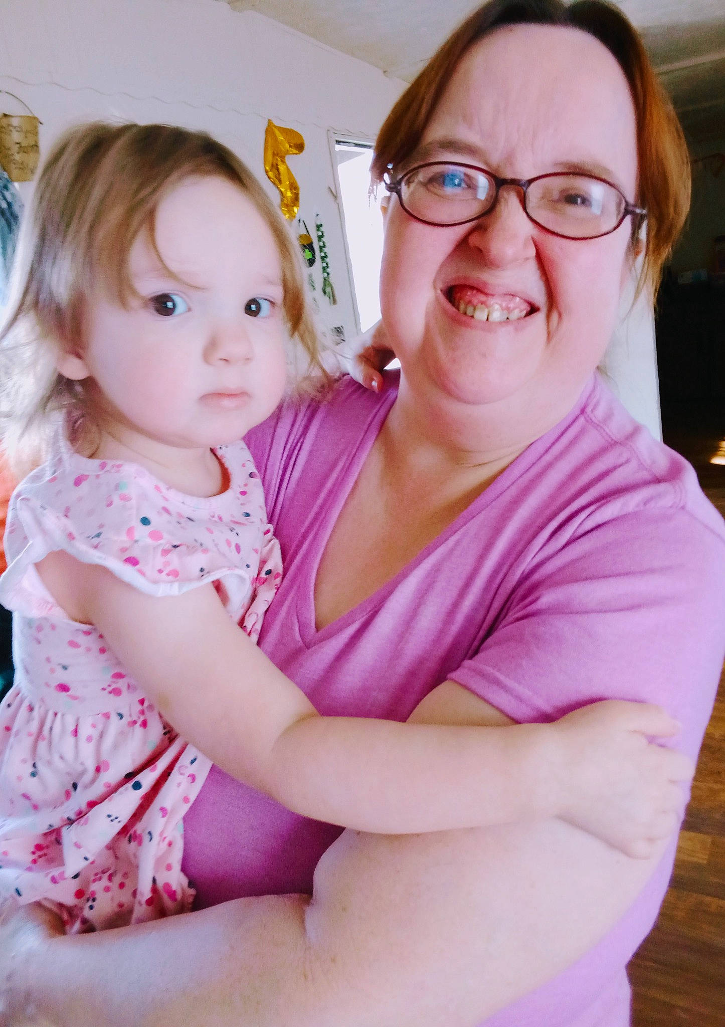 Faith is registered to the contest to win money with this photo: arm, baby, baby_toddler_clothing, cheek, chin, comfort, eyewear, finger, gesture, glasses, hairstyle, happy, iris, joy, mammal, person, pink, shoulder, skin, smile