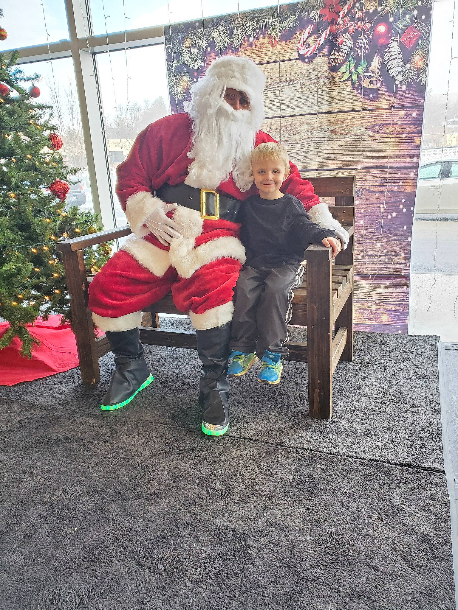 Spencer is registered to the contest to win money with this photo: child, christmas, christmas_eve, christmas_tree, costume, event, fictional_character, holiday, joy, lap, person, plant, santa_claus, sitting, toddler, tree, winter