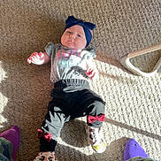 Nala joined the competition — help win amazing prizes! baby, infant, carpet, clothing, headband, shoes, sunlight, floor, person, child, toddler, pants, shirt, bows, purple_socks, home_interior, texture, casual, laying_down, indoor