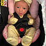 baby, infant, newborn, car_seat, carseat_harness, headband, bow, pink_pillow, onesie, footed_pajamas, buckle, red_button, seat_padding, warning_label, portrait, wide_eyes, open_mouth, floral_blanket, soft_lighting, cute