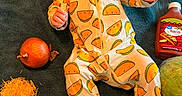 Nala joined the competition — help win amazing prizes! baby, taco_onesie, infant, food, vegetables, cheese, onion, bell_pepper, tomato, lettuce, tortilla, taco_sauce, towel, laying_down, headband, cute, playful, indoor, portrait, colorful