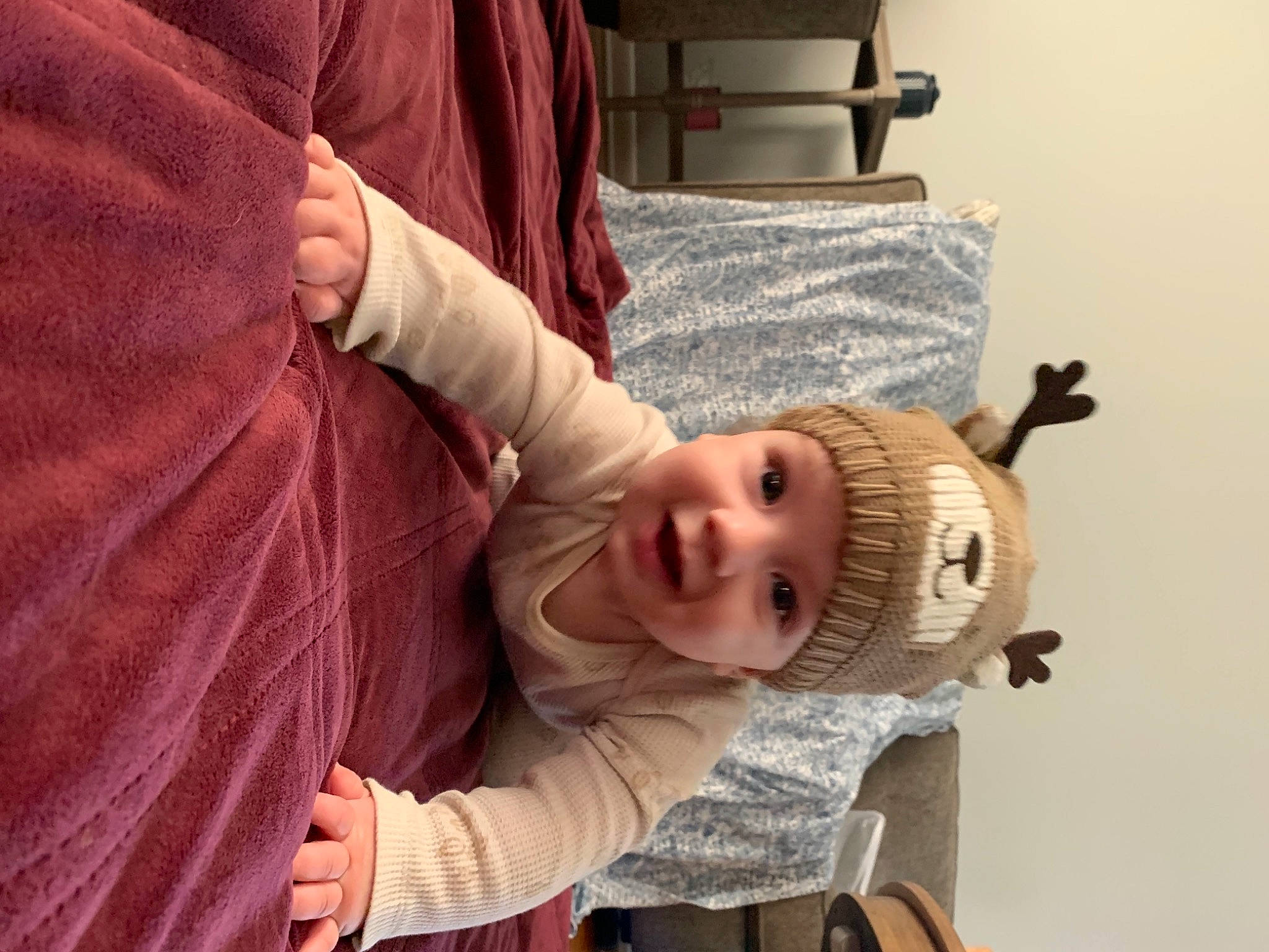 Madden is registered to the contest to win money with this photo: baby, baby_products, baby_safety, baby_toddler_clothing, chair, cheek, child, comfort, fun, fur, gesture, happy, hat, headwear, mouth, person, room, sitting, sleeve, smile