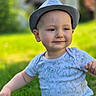 toddler, child, hat, shirt, lion_king, outdoor, grass, smile, portrait, nature, sunlight, greenery, cute, baby, sitting, person, happy, fashion, casual, daylight