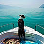 Viko participe au concours pour gagner de l'argent avec cette photo : dog, boat, water, lake, mountains, animal, pet, outdoor, nature, sky, towel, leopard_print, vacation, travel, summer, calm, scenic, adventure, reflection, peaceful