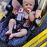 Emery joined the competition — help win amazing prizes! baby, child, car_seat, blue_eyes, blond_hair, sitting, outdoor, sunlight, clothing, stripes, hand, foot, seatbelt, plastic, fabric, floor, yellow, black, person, infant