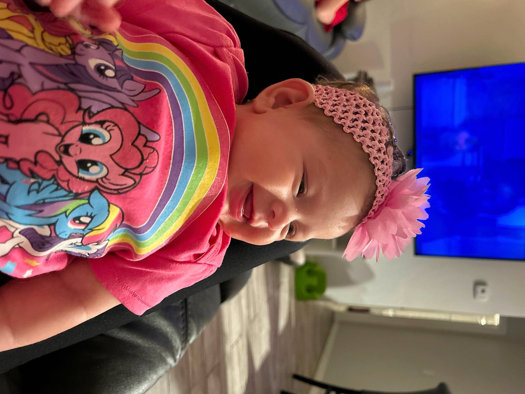 Mazikeen is registered to the contest to win money with this photo: art, baby, baby_toddler_clothing, cheek, child, display_device, fun, happy, magenta, mouth, neck, pattern, person, pink, room, sleeve, smile, sunglasses, t_shirt, toddler