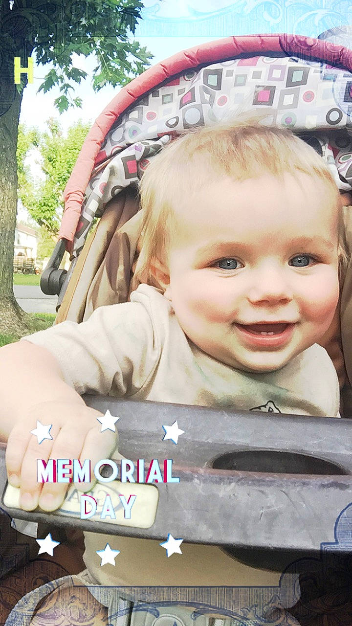 Cole is registered to the contest to win money with this photo: baby, baby_carriage, baby_products, blond, cheek, child, cool, facial_expression, fun, grass, happy, joy, leisure, person, pink, plant, product, skin, smile, toddler