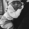 baby, newborn, sleeping, black_and_white, hat, clothing, hand, person, portrait, cozy, infant, closeup, love, care, tired, rest, soft, warm, holding, peaceful