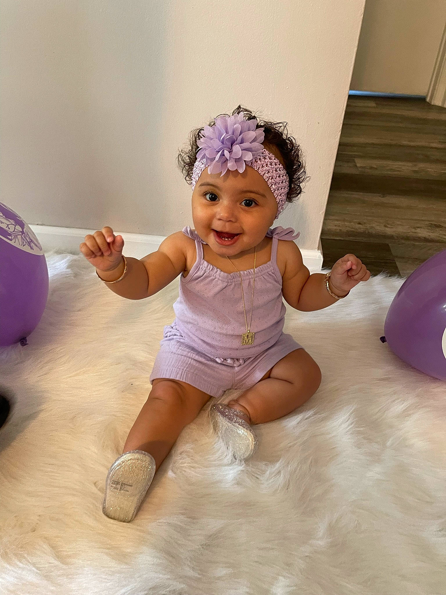 Mercedes is registered to the contest to win money with this photo: baby_toddler_clothing, dress, embellishment, facial_expression, finger, floor, flooring, fun, hairstyle, happy, headgear, headwear, human_body, joy, person, pink, purple, skin, sleeve, smile