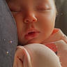 Holly is registered to the contest to win money with this photo: baby, sleeping, infant, closeup, soft_lighting, sparkles, peaceful, cuddling, face, clothing, pink, newborn, portrait, rest, cute, child, skin, relaxation, soft_texture, warmth