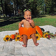 Kahlani joined the competition — help win amazing prizes! toddler, pumpkin, sunflowers, blanket, outdoor, grass, trees, smiling, child, autumn, nature, green_bows, happy, cute, fall, seasonal, baby, sunlight, park, playful