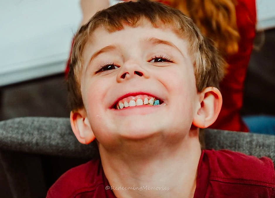 Timothy is registered to the contest to win money with this photo: cheek, child, chin, cool, ear, eyelash, flash_photography, forehead, fun, happy, human_body, jaw, joy, lip, mouth, nose, orange, person, red, smile