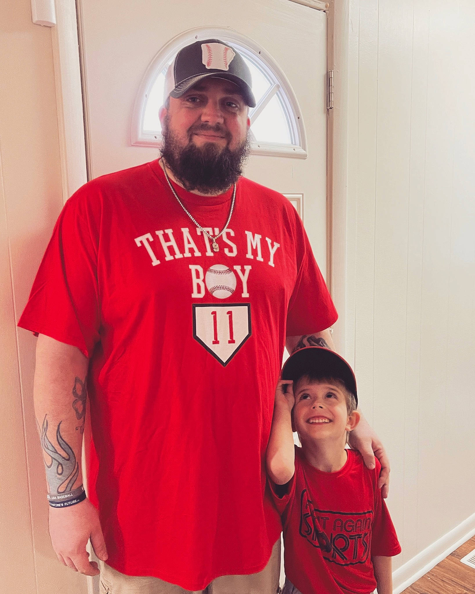 Timothy is registered to the contest to win money with this photo: baseball_cap, beard, cap, cool, eyewear, happy, headgear, headwear, jersey, joy, neck, outerwear, person, red, shirt, shorts, shoulder, sleeve, smile, sportswear