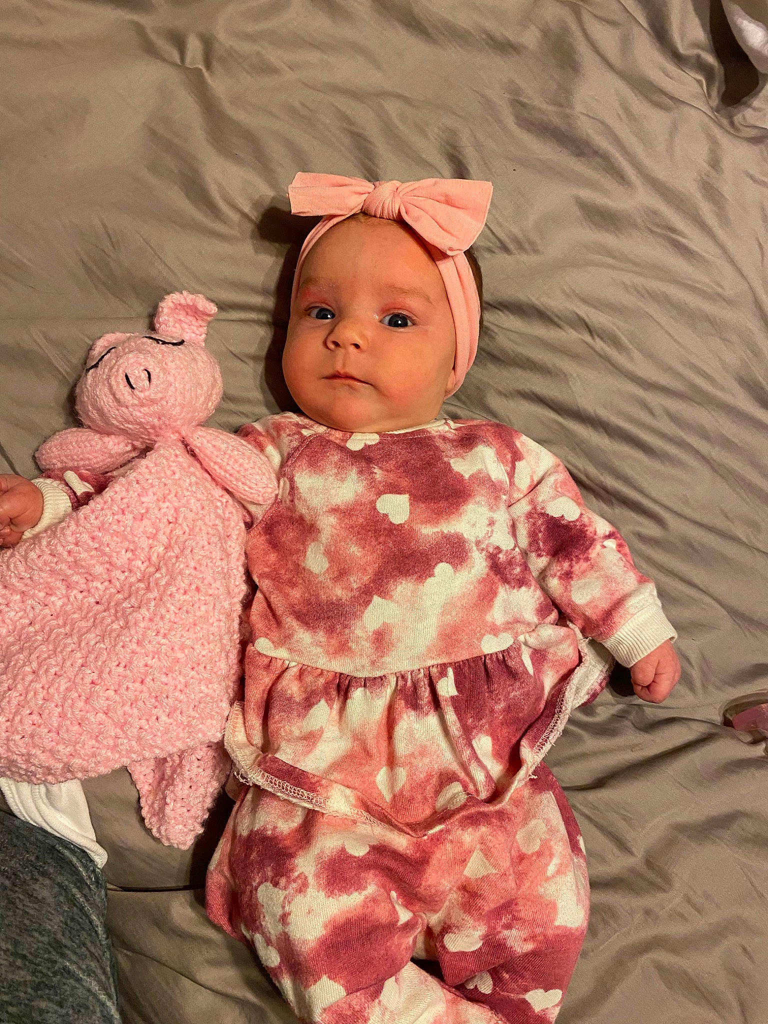 Avery is registered to the contest to win money with this photo: baby, baby_toddler_clothing, baby_toys, cheek, child, doll, dress, eye, head, headwear, linens, one_piece_garment, pattern, peach, person, pink, room, skin, sleeve, stuffed_toy
