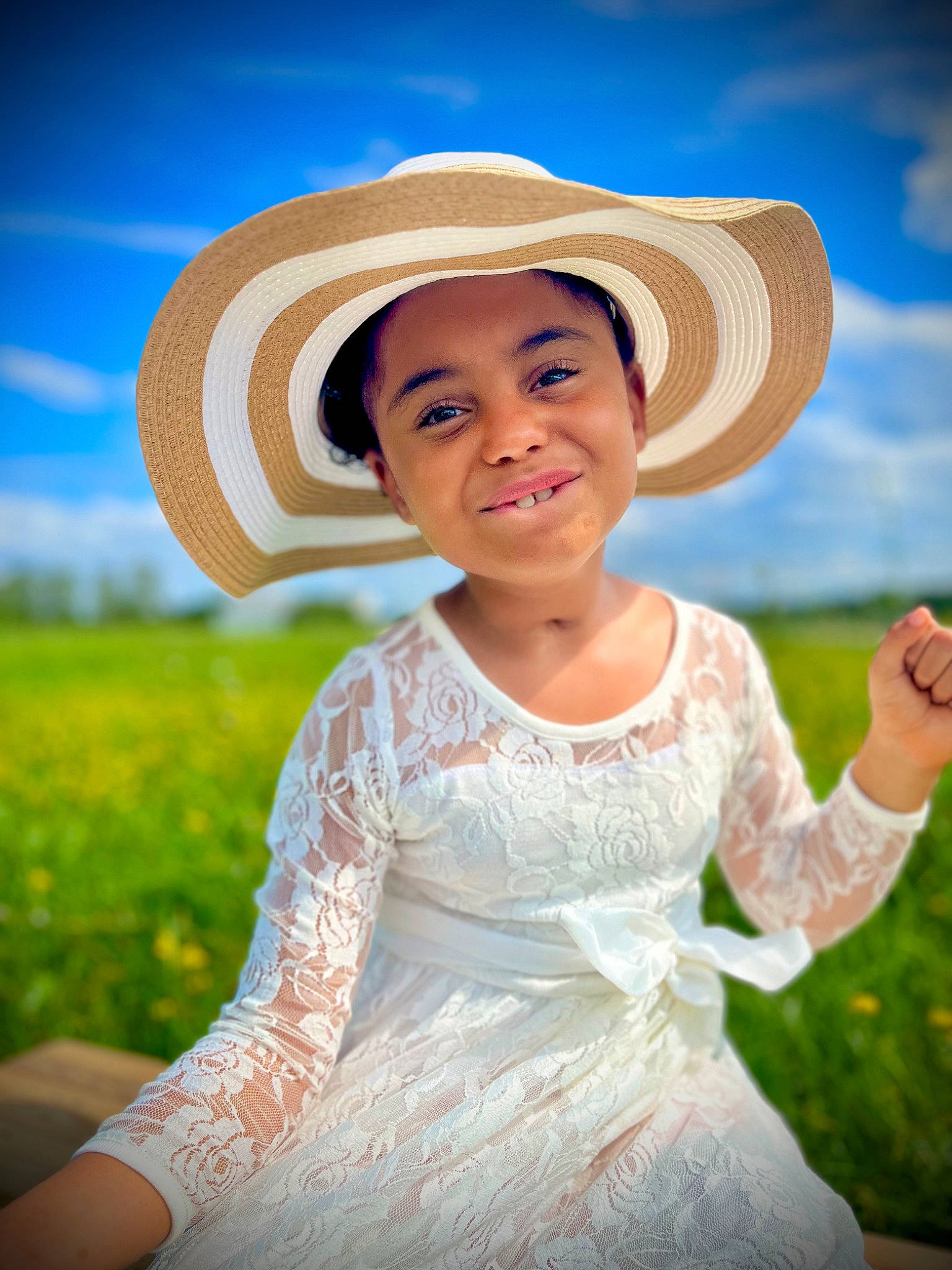 Winter is registered to the contest to win money with this photo: blue, child, dress, facial_expression, flash_photography, fun, grass, grassland, happy, hat, headgear, headwear, joy, landscape, meadow, people_in_nature, person, plant, recreation, skin