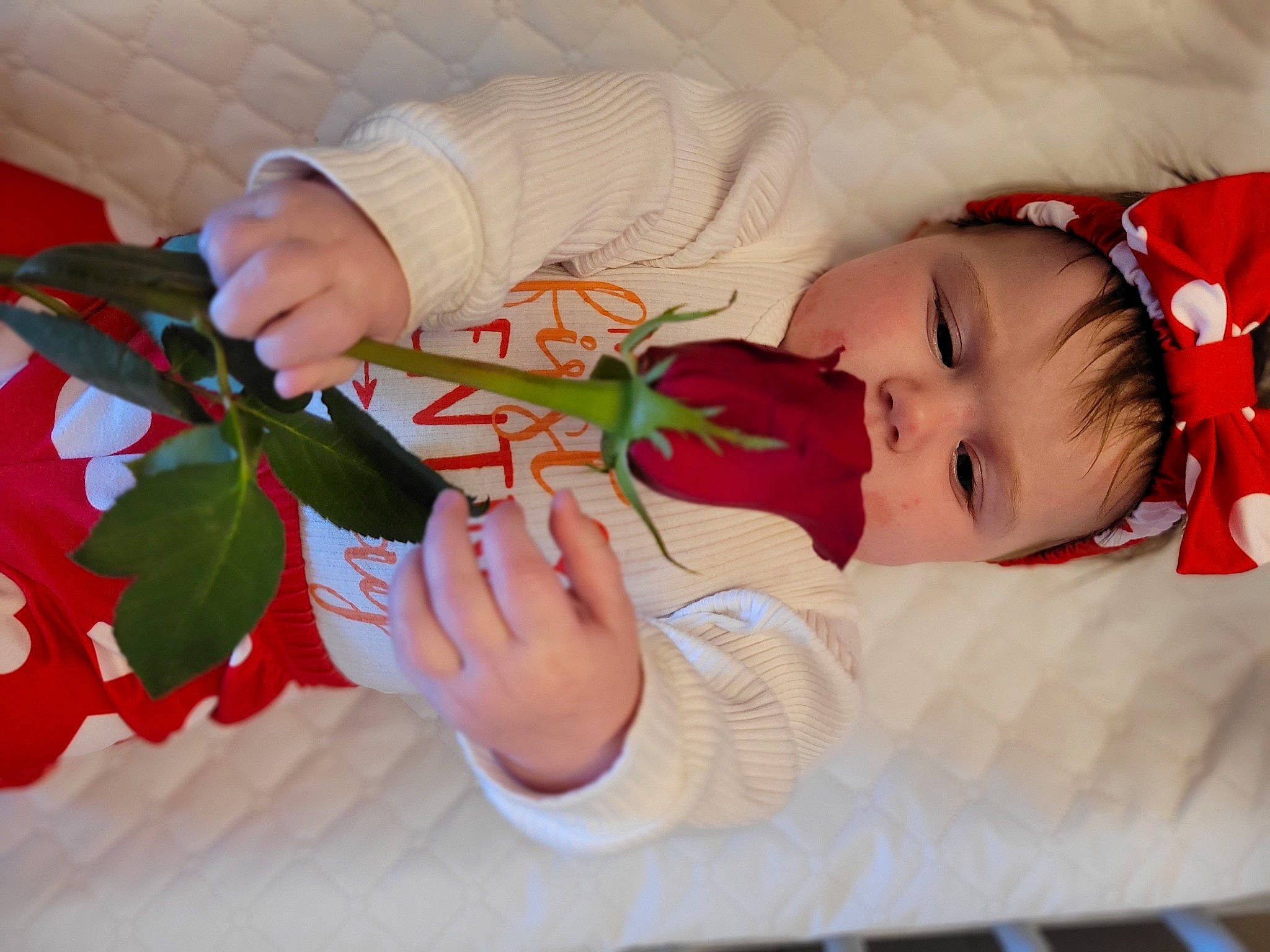 River is registered to the contest to win money with this photo: arm, baby, baby_toddler_clothing, carmine, child, comfort, finger, gesture, hand, happy, human_body, lip, nail, pattern, person, petal, plant, skin, thumb, toddler