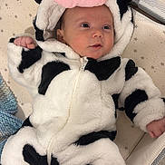 Nathan joined the competition — help win amazing prizes! baby, infant, cow_onesie, hood, plush_hat, crib, mattress, star_pattern, blanket, socks, face, smile, hand, lying_down, soft_fabric, cute, newborn, warning_label, black_and_white_spots, portrait