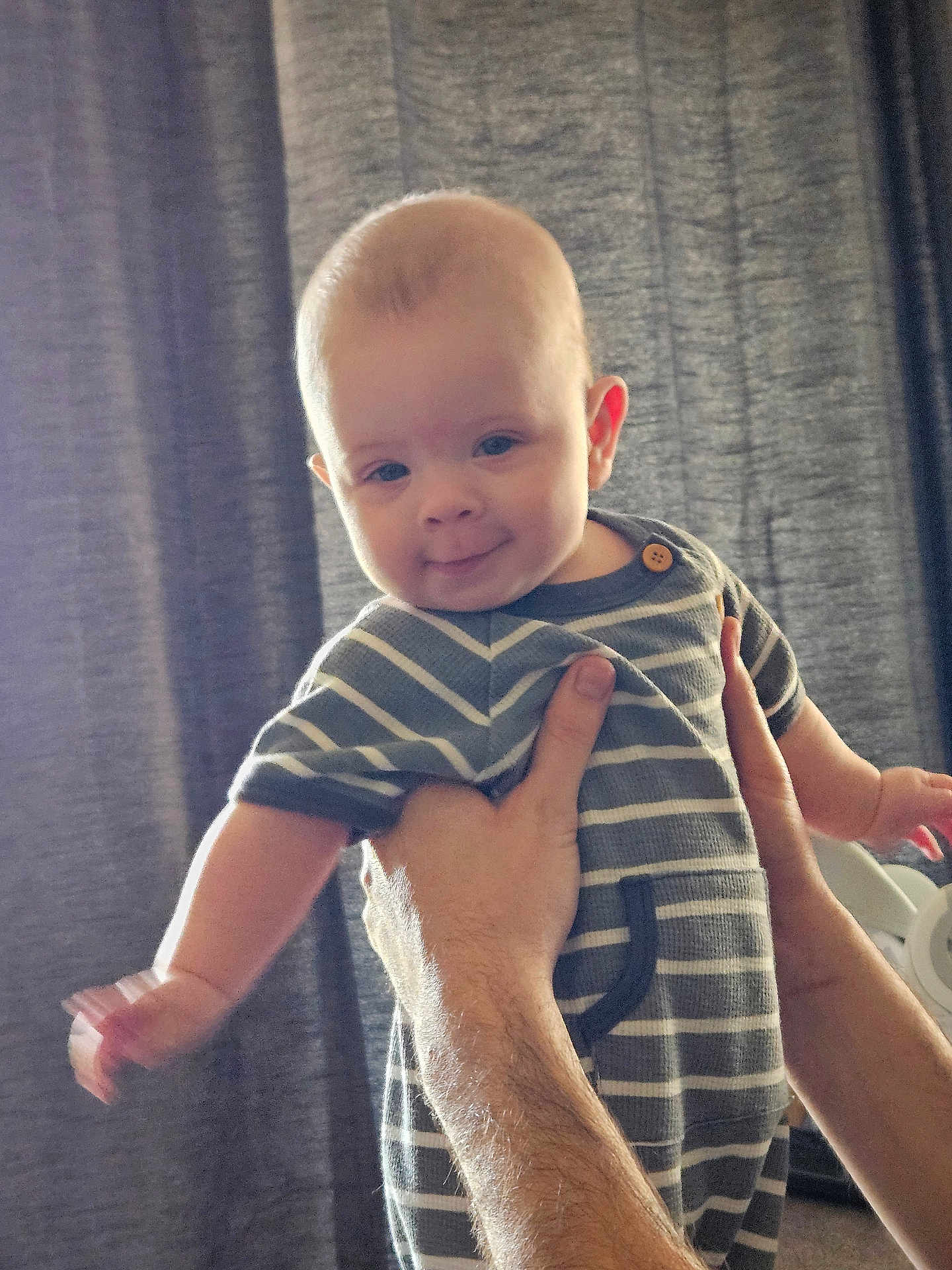 Nico Finnley joined the competition — help win amazing prizes! adult, arm, baby, background, child, curtain, cute, face, hand, happy, holding, human, indoor, infant, onesie, person, portrait, skin, smile, striped_clothing