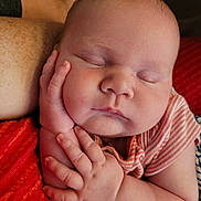 Braelynn joined the competition — help win amazing prizes! baby, sleeping, infant, hand, face, arm, striped_clothing, cushion, red, skin, peaceful, closeup, portrait, child, newborn, resting, soft_light, indoors, human, relaxation