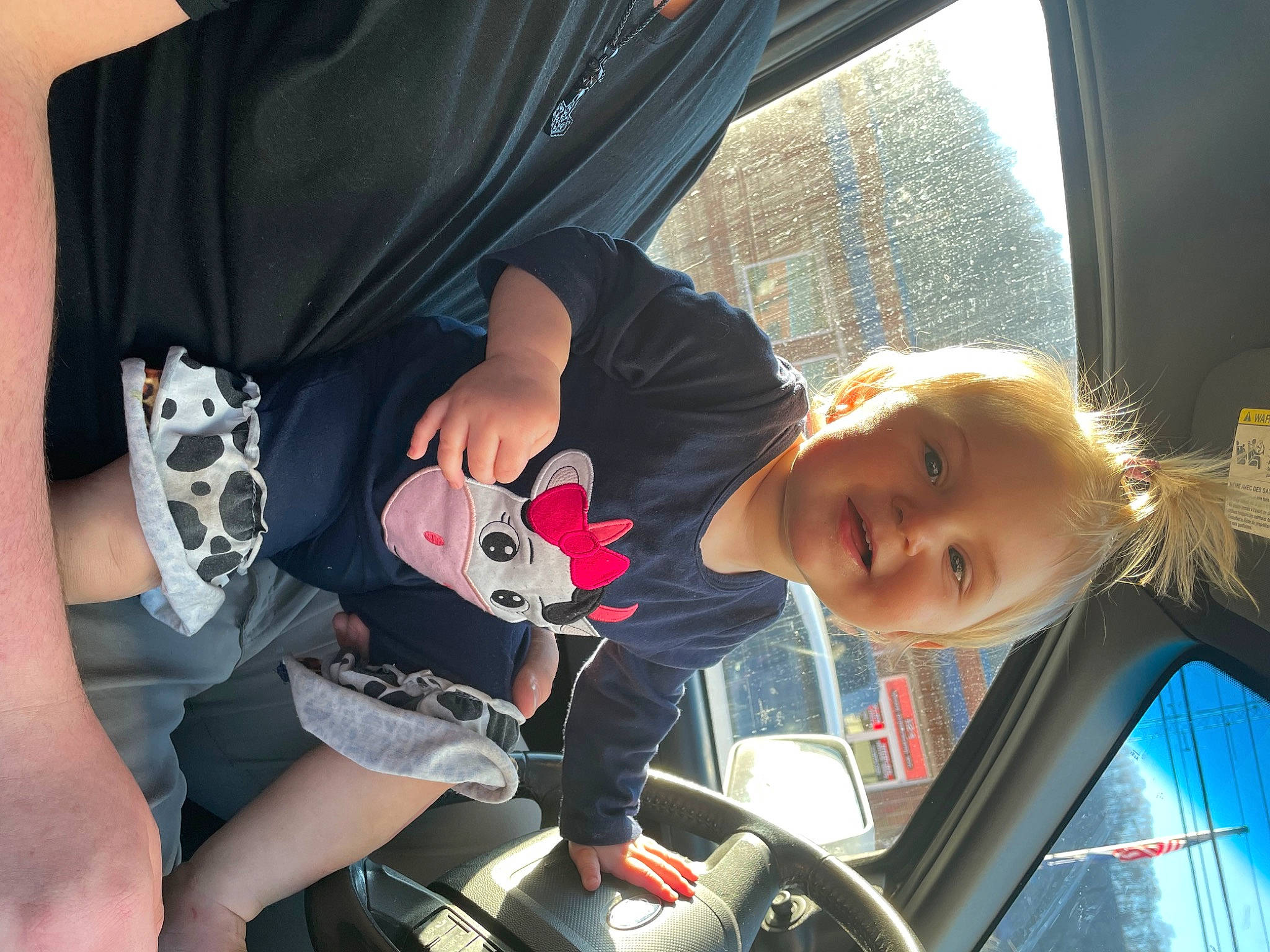 Olivia is registered to the contest to win money with this photo: automotive_design, automotive_exterior, automotive_lighting, car, car_seat, cool, finger, fun, gesture, hairstyle, hand, happy, joy, motor_vehicle, mouth, person, smile, toddler, vehicle, vehicle_door