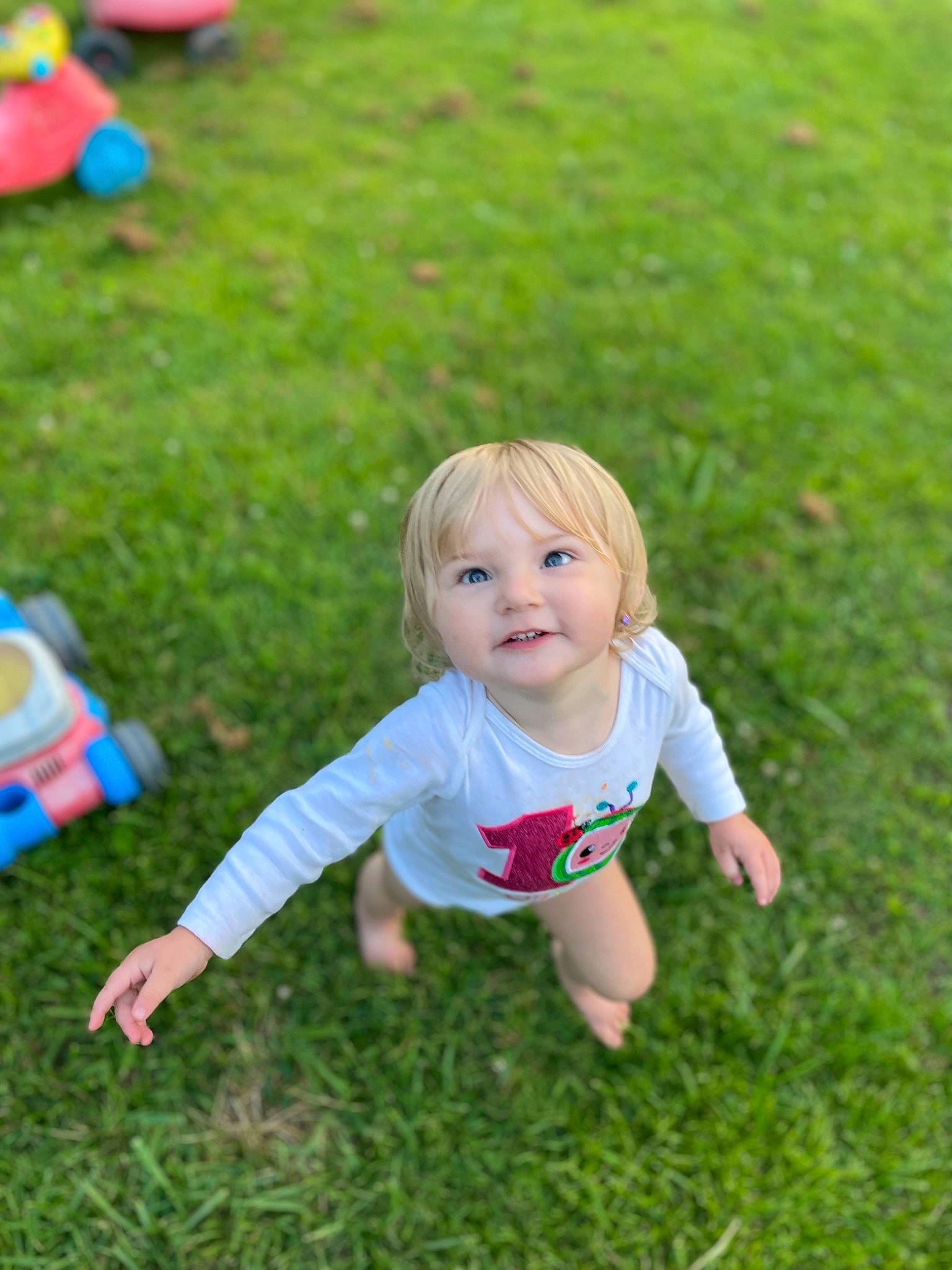 Olivia joined the competition — help win amazing prizes! baby_toddler_clothing, child, grass, grass_family, grassland, green, happy, joy, leaf, leisure, meadow, natural_environment, nature, people_in_nature, person, pink, plant, recreation, smile, summer