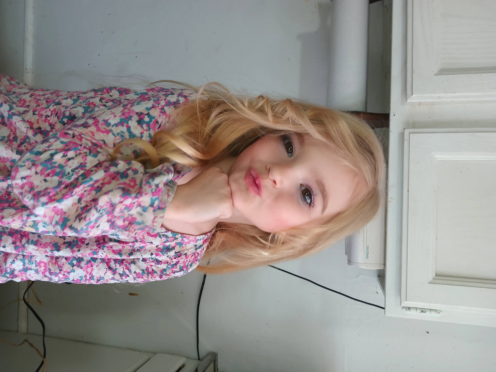 Paislee is registered to the contest to win money with this photo: blond, brown_hair, child, comfort, couch, eyelash, flooring, fun, happy, human_leg, kitchen_appliance, linens, magenta, person, pink, room, sitting, smile, toddler, wood