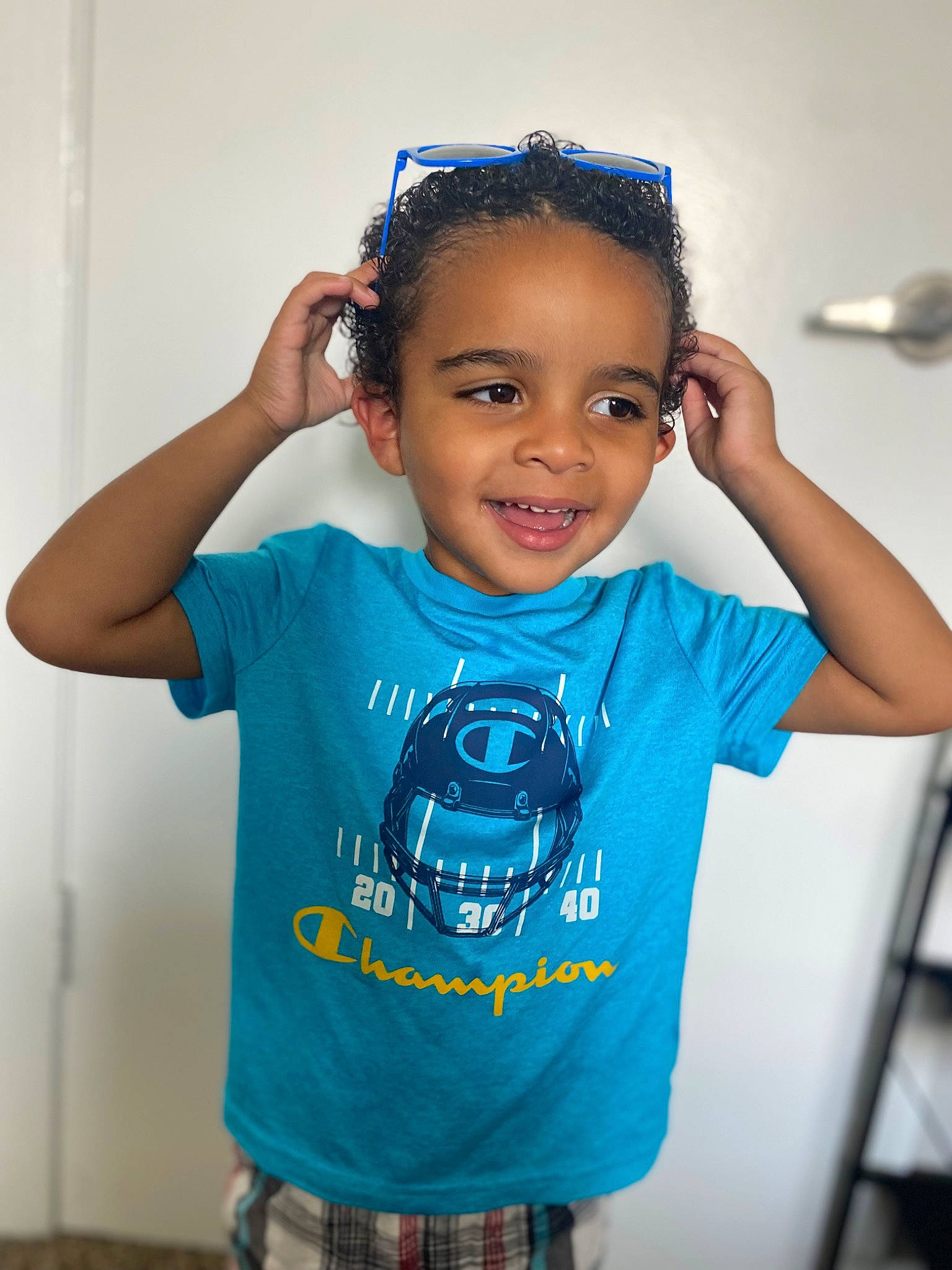 Jabari is registered to the contest to win money with this photo: arm, audio_equipment, black_hair, blue, child, cool, electric_blue, eyelash, flash_photography, gesture, happy, joint, joy, neck, person, product, shoulder, sleeve, smile, standing