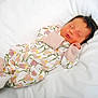 baby, blanket, child, clothing, cozy, cute, face, floral_pattern, hands, head, indoors, infant, newborn, onesie, peaceful, portrait, resting, sleeping, soft, white