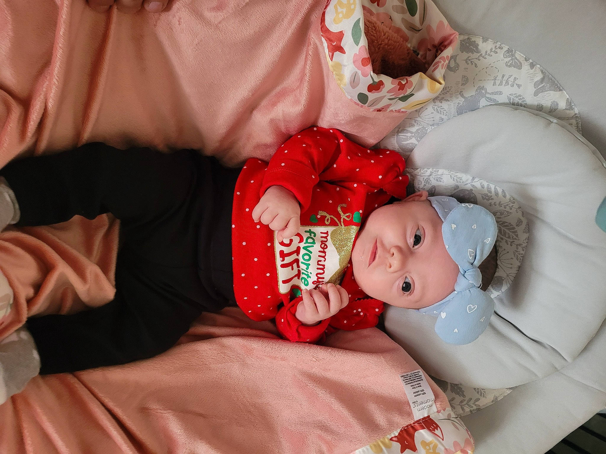 Raynee is registered to the contest to win money with this photo: baby, baby_toddler_clothing, child, comfort, dress, event, facial_expression, fashion_accessory, hand, hat, head, headwear, human_body, jewellery, person, pink, plant, room, skin, sleeve